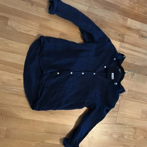 Mörkblå skjorta med knappar - Snygg mörkblå skjorta med knappar framtill. Perfekt för en stilren look. Skjortan är Gant och är värd 800kr
