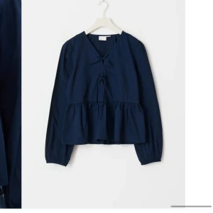 Mörkblå tröja från Gina tricot - Gina tröja i storlek 158/164. En t-shirt med små rosetter på och volang längst ner vit toppen. Användas 2-3 gånger så är i bra skick!💙