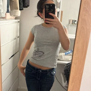 Vintage grå t-shirt med tryck - Säljer en grå t-shirt från Zara med ett lila kron tryck. T-shirten har korta ärmar och en rund urigning. Skit snygg tröja som inte används längre💕😍