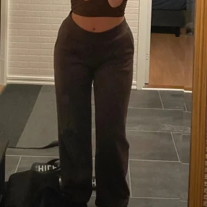 Bruna byxor - Säljer ett par snygga bruna byxor i loose fit. De är lågmidjade och perfekta för både vardag och fest. Byxorna har en stilren design utan mönster eller extra detaljer. Passar bra till en croppad topp eller en stickad tröja för en mer avslappnad look.
