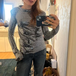 Glittrig långärmad topp från Rodebjer - Säljer silvrig glittrig topp från Rodebjer. Det står ingen storlek på plagget men jag skulle säga storlek S/36