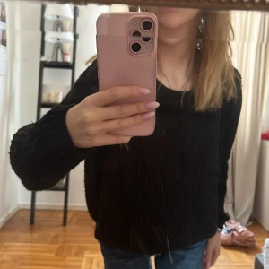 Svart stickad tröja - Säljer en svart stickad tröja med långärmad design. Perfekt för kyligare dagar och enkel att matcha med olika outfits. Tröjan har en klassisk look och är bekväm att bära.