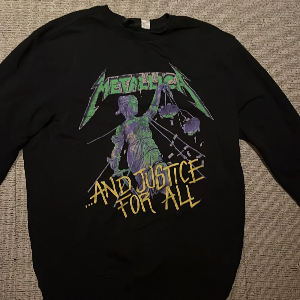 Säljer en svart tjocktröja från H&M med Metallica-tryck och texten ’'...And Justice For All'.. Neuletakit & Villapaidat.