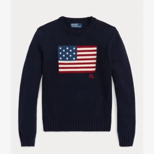 Mörkblå stickad tröja från Ralph Lauren - Säljer en snygg mörkblå stickad tröja från Ralph Lauren med en stor amerikansk flagga på bröstet. Tröjan är använd fåtal gånger. Pris kan diskuteras vid snabb affär. Skriv för bilder på tröjan!
