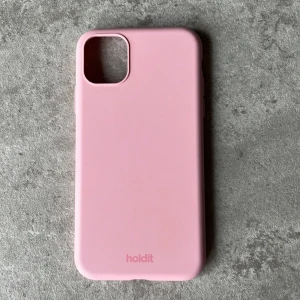 Rosa mobilskal från Holdit - Säljer ett stilrent rosa mobilskal från Holdit till en IPhone 11. Skalet är designat för att skydda din telefon och har en mjuk yta som ger ett bra grepp.💞💞