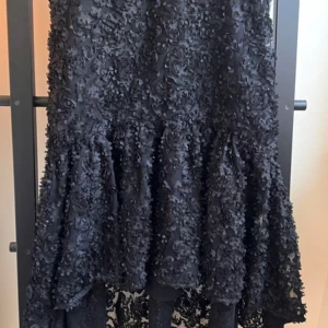 Black flamenco inspired skirt  - A beauty black flamenco inspired skirt with black flowers and tulle. Shorter in the front, longer in the back. Only used 2 times. Size S 
