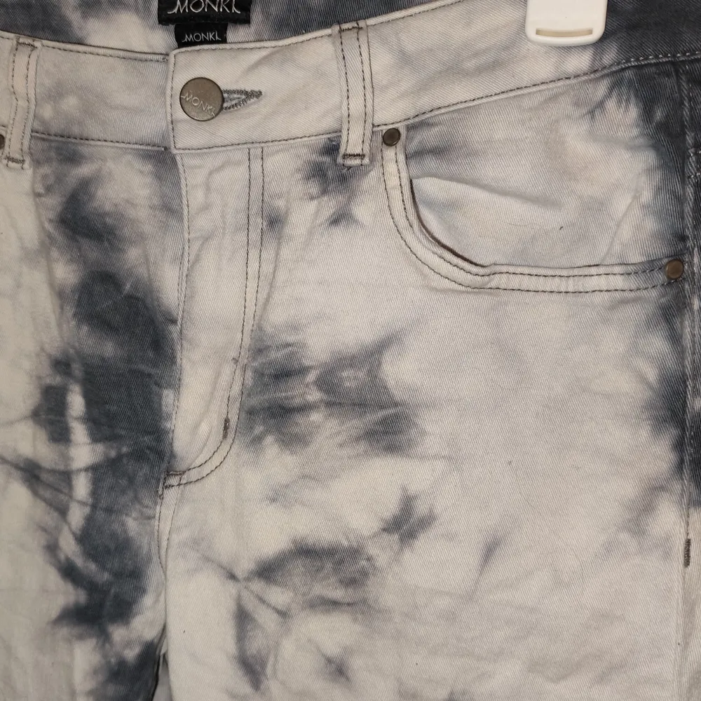 Säljer ett par snygga tie-dye jeans från Monki i storlek M. De har en cool blå och vit mönster och är i mycket bra skick. Perfekta för att ge din outfit en unik touch! 💙🤍. Jeans & Byxor.