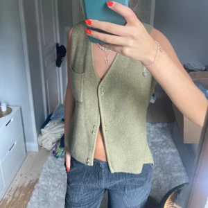 Stickad väst - Säljer min såå fina och sköna stickade väst från nana shi i en assnygg grön beige färg. 