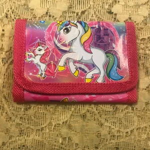 Barn plånbok med enhörningsmotiv - Säljer en superfin rosa plånbok med färgglada enhörningar och stjärnor. Perfekt för att hålla dina pengar och kort säkra. Den har en praktisk kardborrestängning och är lätt att bära med sig. Perfekt för enhörningsälskare! 🦄✨. 55kr/st  , sammafrakt 