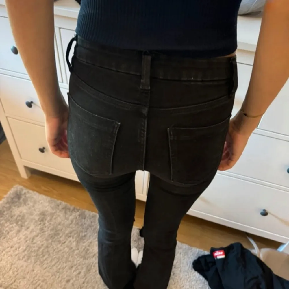 Säljer ett par svarta utsvängda jeans i mycket bra skick. De är lågmidjade och har en snygg passform som sitter tight. Perfekta för både vardag och fest! 🖤. Jeans & Byxor.