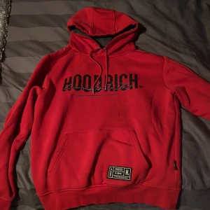 Röd hoodie från Hoodrich - Säljer en snygg röd hoodie från Hoodrich i storlek S. Nåra fläckar på framsidan som jag inte lyckats få bort säljs därför billligt
