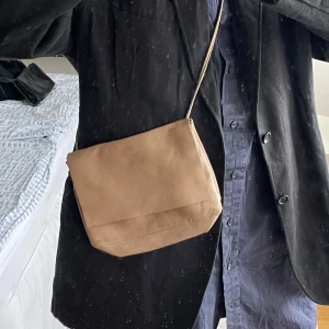 Beige axelväska från COS - Säljer en snygg beige skinnväska från COS. I fint skick!