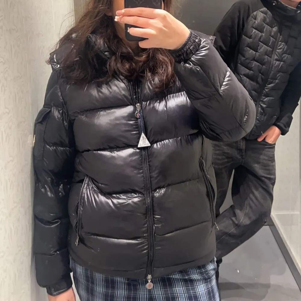 Säljer en snygg svart moncler maya i mycket bra skick. men bara ett litet hål på armen som man knappast ser. Den är perfekt för kalla dagar med sin quiltade design och dragkedja framtill. Jackan har långa ärmar och en skön passform som håller dig varm och stilren. Perfekt för både höst och vinter! äkta köpt för 16 tusen säljer billigt pågrund av skadan på armen, äkteihets bevis finns och fler bilder kan skickas. Jackor.