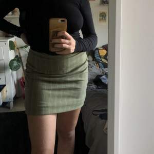 superfin retrogrön kjol med kritstreck köpt secondhand. är lite längre egentligen, strax ovanför knäna, men har vikt upp den på bilden. har en liten slits på baksidan. jättebra skick!