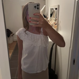Blus - Superfin one-shoulder blus med volang och broderi detaljer. Från Mango. Storlek 164 men skulle säga att den passar en S. 160kr.