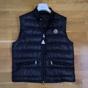 Moncler Gui Väst - Säljer en knappt använd väl skött moncler gui väst. Cond 9/10 som ny skick. Tveka inte på att höra av er om ni vill ha fler bilder eller om ni har någon fråga! Pris kan diskuteras vid smidig affär. Allt följer självklart med