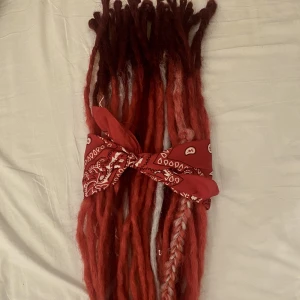 Unika SE dreadlock extensions 70-75cm - Handgjorda se dreadlocks i klar röd med mörkare rötter och blonda (bleach+platina) highlights. Endast använda i en vecka och urtagna pga byte av hårfärg. coola grunge/punk inspirerade, 70-75cm, single ended, 32st, medium breda, 270g, syntet så lättskötta