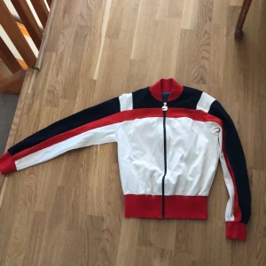Fila tröja - Klassisk fila-tröja med dragkedja. Har nog några år på nacken. Hänget på dragkedjan har lite skönhetsfläckar. Se bild.
