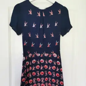 Superfin mörkblå klänning med fåglar på. Perfekt till sommaren! Så snygg passform och design 😍 Bra skick!