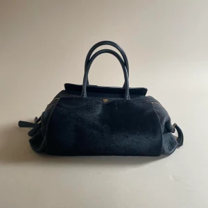MCM RARE Black Handbag - Rare Vintage MCM Designer Bag  Made in Italy  Luxury Black Leather with Black Ponyhair Frontal Pockets. MCM doesn’t make much Leather product today but this is a special piece using beautiful materials.  Please send any questions, cannot write much here