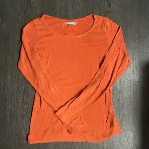 långärmad tröja i fin orange färg!