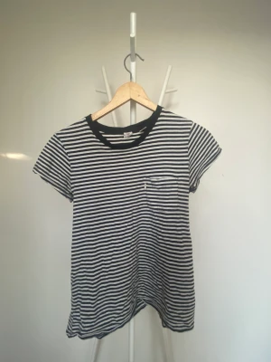 Levis t-shirt - En Levis t-shirt med randigt mönster i svart och vit med en liten ficka på framsidan  Använd ett par ggr där av så billig