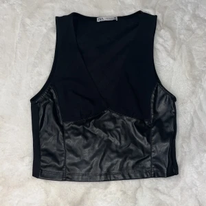 Topp Zara - Svart topp med skinndetaljer från zara, använd en gång