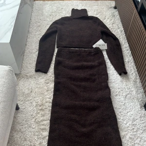 Stickad set  - Jättefint set från NA-KD, en stickad croppad tröja och stickad midikjol. Aldrig använd med prislapp kvar på kjolen. 