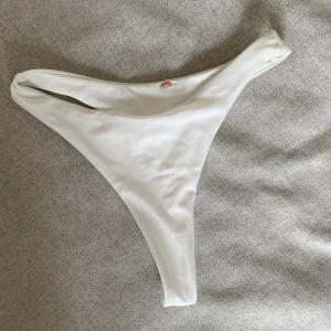 Vit Bikiniunderdel- Nelly - Helt oanvänd underdel från Nelly. Har klippt bort lappen i tro om att jag skulle använda den under en resa. 