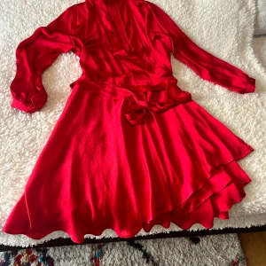 A very beautiful red dress  - I am selling this beautiful dress because i rarely use . I have won the dress twice. So it is in Good condition Good colour and fits perfectly Good.and Hey it is of Good quality.