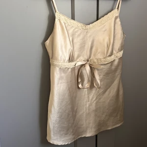 Söt guldig topp med rosett - Söt topp med band som man kan knyta i midjan. Köp genom ”köp nu”