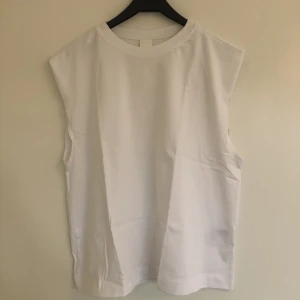 Ärmlös t-shirt  - Helt ny, oanvänd ärmlös t-shirt. Skönt material. Tjockare tyg över axlarna. Oversized så passar både mindre och större storlekar beroende på hur man vill att den ska sitta. 