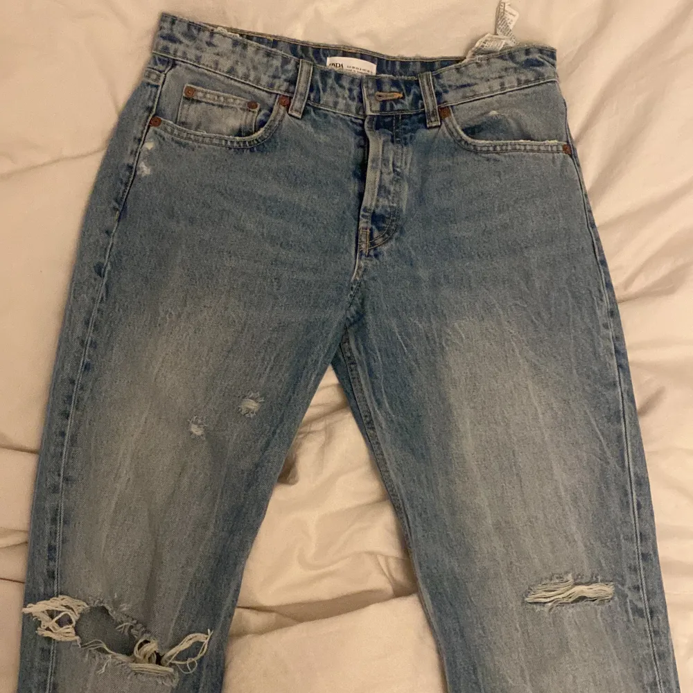 Säljer mina nästintill oanvända zara jeans då dom inte kommit till användning, storlek 38/m och sitter bra på mig som är 173. Ljuset kan se lite gult ut men dem är i en fräsch blå med lite snygga slitningar! Fler bilder vid intresse!🙏🏽. Jeans & Byxor.