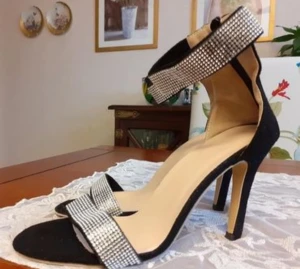 Sandalett  - Sandalett med 10 cm klack (mätt längst bak). Svart syntetmaterial med silver. Stl 40. Endast provade.