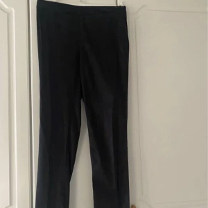 Svarta kostymbyxor  - Svarta kostymbyxor (lite blanka) från H&M. Storlek 38.