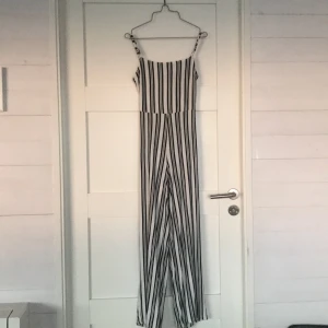 Randig byxdress - Vit- och svartrandig byxdress från stradivarius med fin rygg. Storlek 26 och passar som xs.
