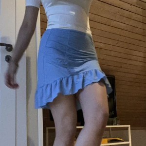 Blå kort kjol - Skön och luftig. Passar till mycket. Använd ganska mycket, men inget slitage. Lappen är bortklippt pga kliade så mycket