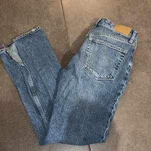 Jeans Gina tricot  - Mörkblåa jeans från Gina tricot med egenklippt slits på insidan. Inte så använda och är i momjeans stilen.