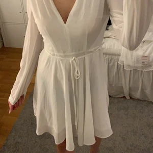 Vit klänning  - Superfin klännig perfekt till både skolavslutning eller student. Den är i väldigt bra skick då den endast är använd 1 gång. Drakedja i ryggen och snöre vid midjan.