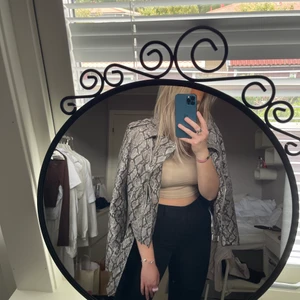 Skinnjacka  - Skinnjacka i ormskinnsmönster från nakd! Super ball att ha till det mesta men gjort sitt i min garderob! Är storlek L men är ganska liten i storleken!