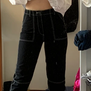 Hm svarta byxor med vita sömmar - Använt ca 3 ggr. Väldigt snygga men lite för korta på mig som är ca 170 cm. Funkar dock med tex ett par höga converse. Frakt ingår inte. Vet ej storlek men själv är jag 36 så skulle gissa på något runt det. Passar även superbra på folk med mindre storlek!! Högmidjade!