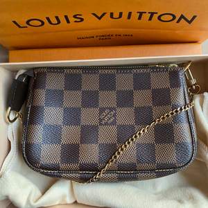 Selling my un-used authentic Louis Vuitton mini pochette in damier ebene pattern. Condition is as new and it comes with original duster bag and packaging.