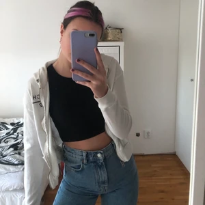 Kofta från A&F - Vit kofta/munkjacka från abercrombie and fitch med tryck på bröstet och på ryggen, storlek S men kort i modellen