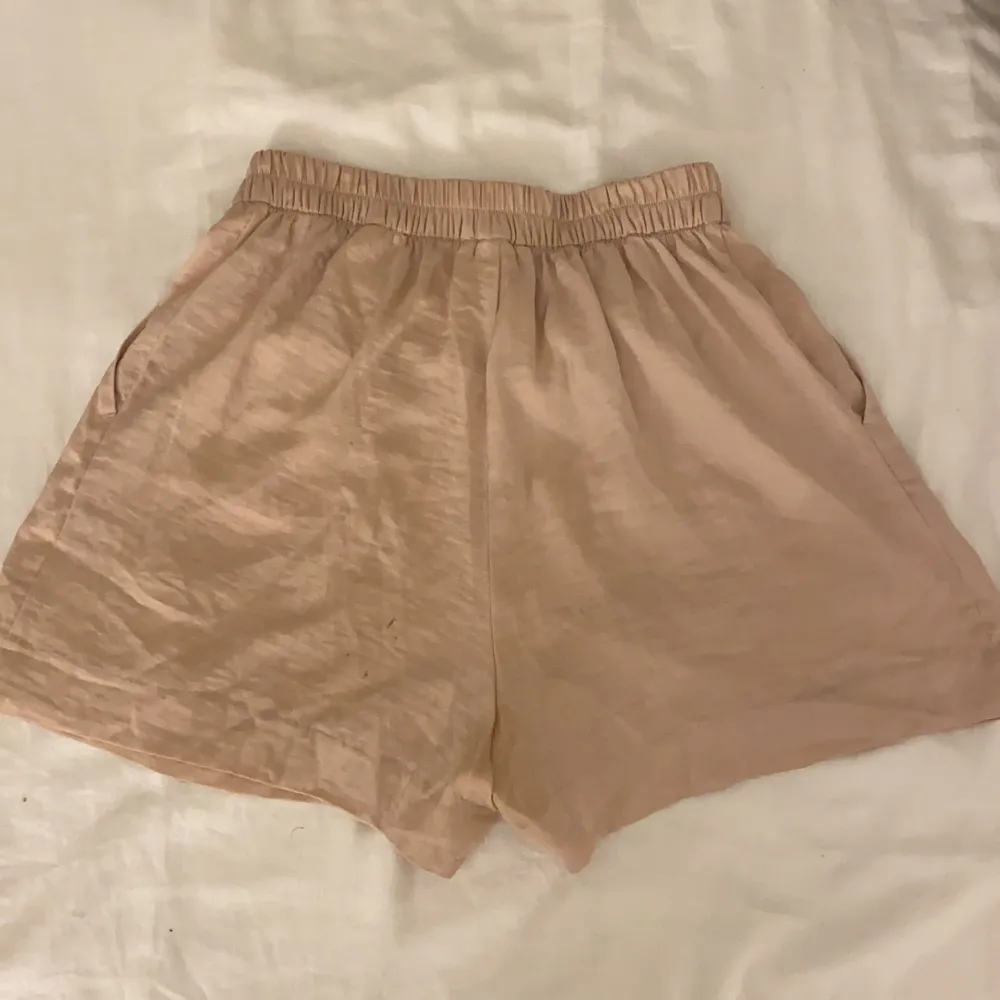 Gammalrosa shorts i siden med superhög midja och resår. Köpta från HM i storlek 32. Finns små fläckar i bak som knappt syns när man har de på sig (bild 2 eller 3). Gratis frakt! . Shorts.