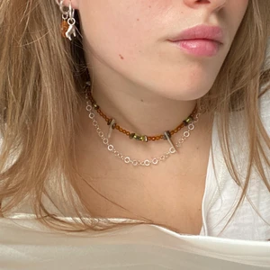 Halsband - Handgjort halsband av mig. Spänne och tag av 925 silver. Pärlor av glas, snäckskal samt tigeröga. Längd 27 cm (storlek xs) se min Instagram @scillasmycken för mer!