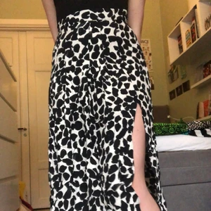 Svart fläckig kjol - Fin vit och svart-fläckig kjol med slitsar på båda sidor. Tunt material så perfekt sommarkjol! Köparen står för frakt men möter annars upp i Stockholm 🌟