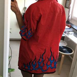 red short sleeved button up with blue flames