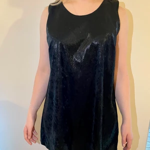 Den perfekta lilla svarta klänningen  - Tyget har en modern snakeskin effekt. Storlek: M men passar även en S Material: Polyester 100%  Skick: Utan anmärkning Färg: Svart