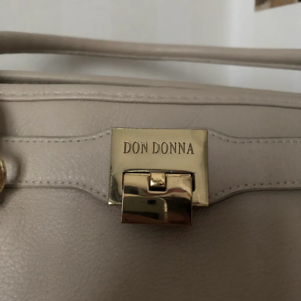 En fin Don Donna väska fin skick. Mycket utrymme för saker i väskan två fickor med dragkedja och två öppna. Nypris 1000kr . Väskor.
