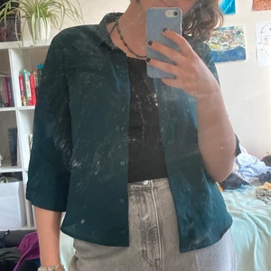 Mörkgrön blus - Säljer den här blusen/skjortan från Monki! Den är grönare i verkligheten!💚 Saknar dock en knapp men den går fortfarande att knäppa utan att det syns och den är väldigt snygg uppknäppt! Köparen står för frakt.✨🌺